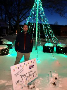 Alec Connolly, a UT junior majoring in electrical engineering who is working a co-op at iHeartMedia, posed for a photo by the lights that he synced for 101.5’s Christmas on the River.